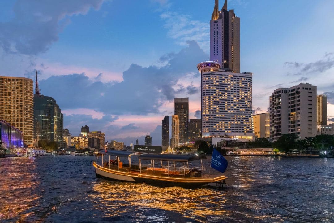 A panoramic view of the Chao Phraya River at twilight seen from the Millennium Hilton Bangkok's ThreeSixty Jazz Lounge glass cupola.