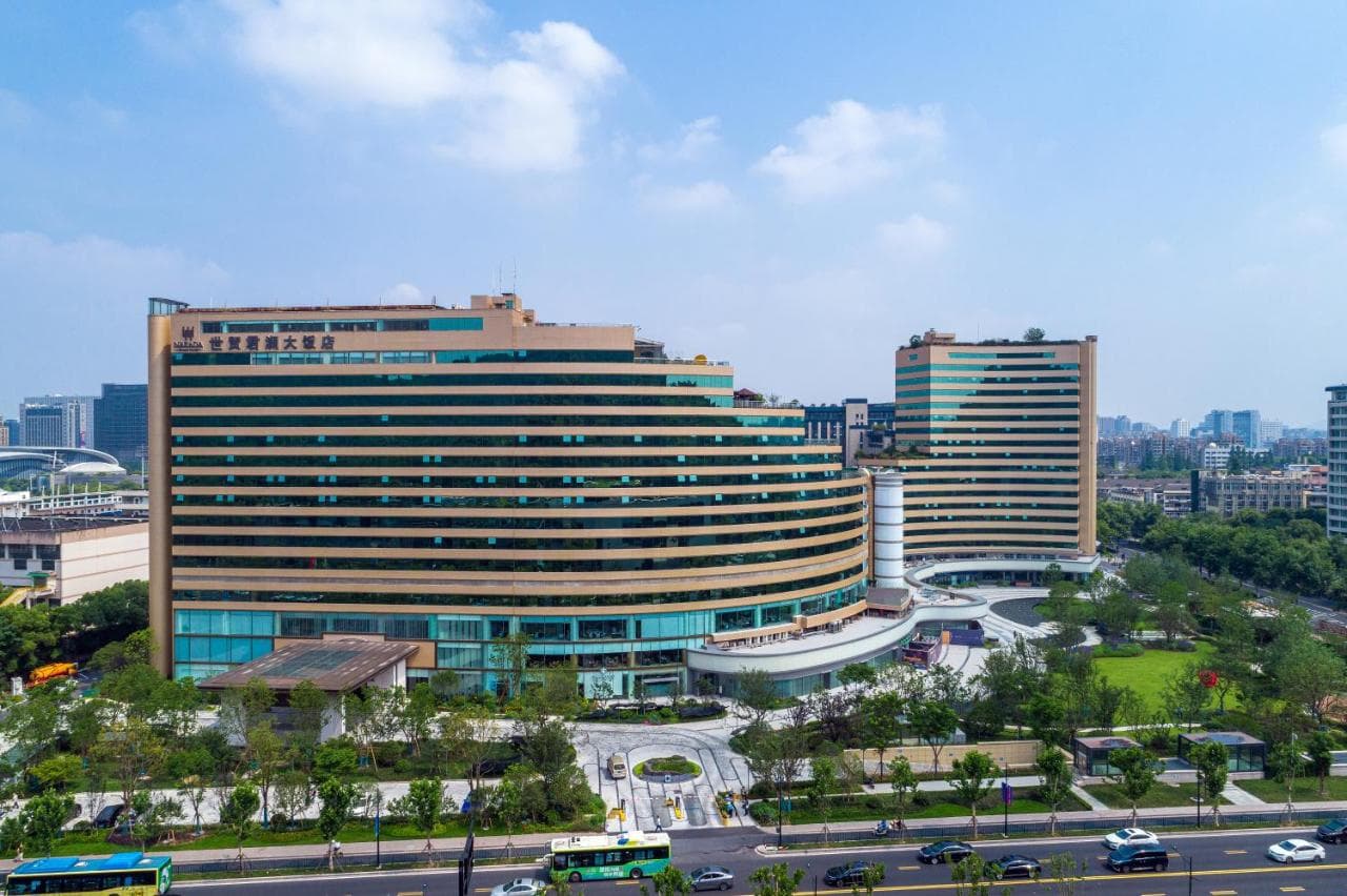 Indoor swimming pool at Zhejiang Narada Grand Hotel with floor-to-ceiling windows facing a lush green forest.