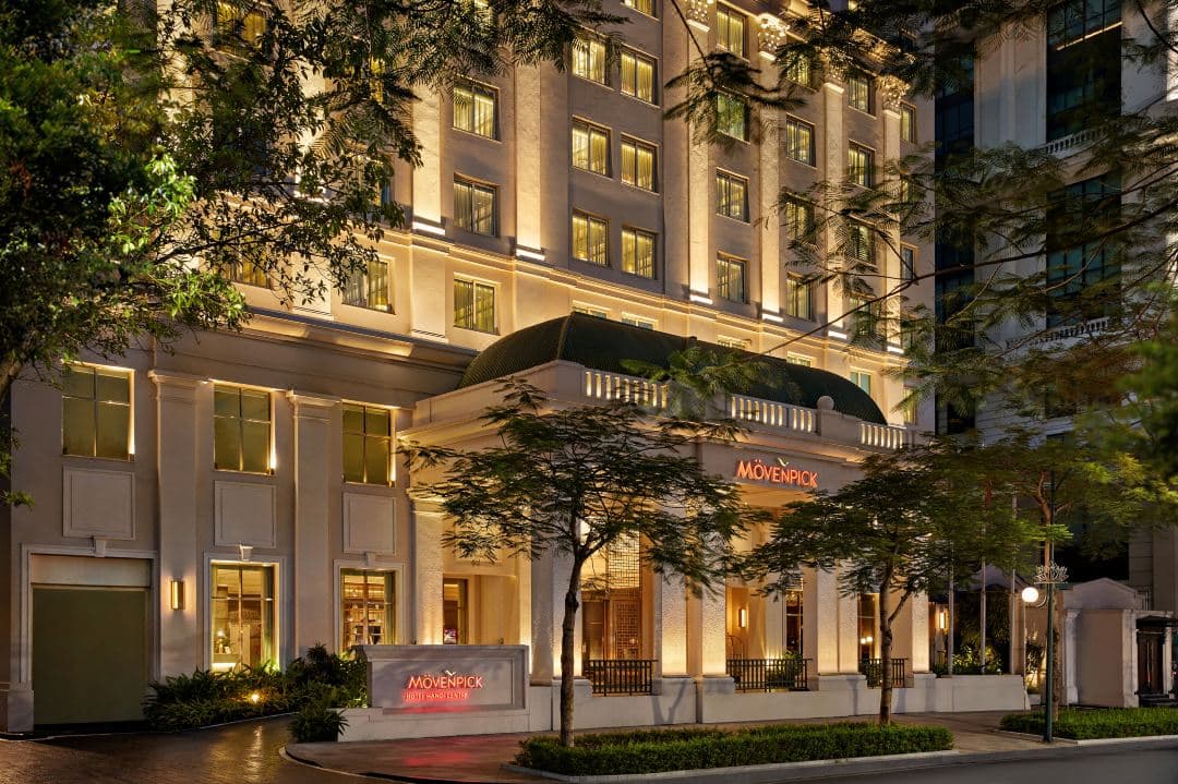 Mövenpick Hotel Hanoi Centre exterior showing French colonial architecture with refreshed modern interior lighting and Cabana Club pool area.