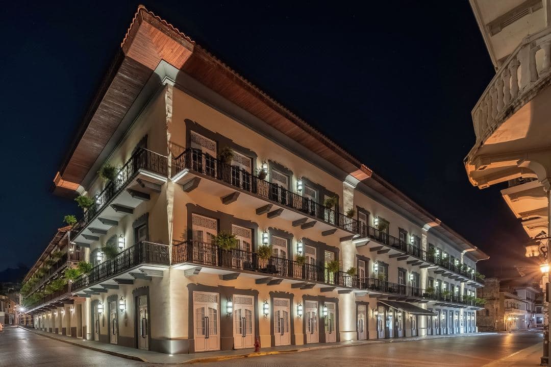 The Capella Rooftop Bar at sunset featuring a sleek leisure pool, sun deck, and panoramic views of the Panama City skyline contrasting with the historic Casco Viejo architecture.