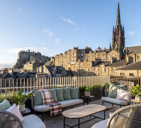 The Oculus Lounge at Virgin Hotels Edinburgh featuring a restored 19th-century glass dome and circular seating.