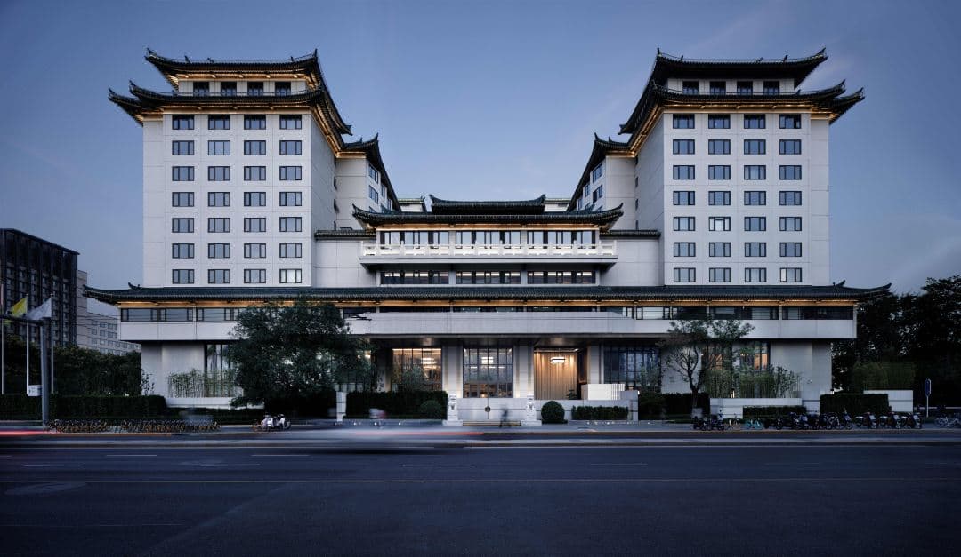 Luxurious room interior at Prime Hotel Beijing with modern amenities and a city view.