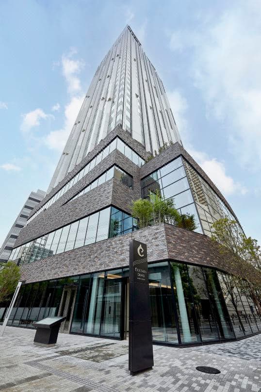 A dramatic view of the Centara Grand Osaka's 'Lantern' elevator hall featuring glowing Thai-inspired light installations.