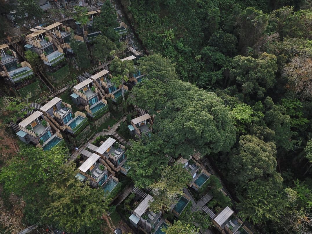 Wooden funicular ascending through dense jungle foliage at Dinso Resort Phuket