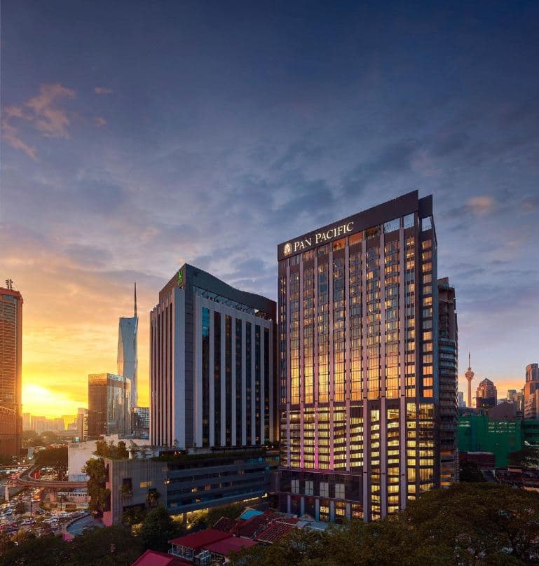 Rooftop infinity pool at Pan Pacific Serviced Suites Kuala Lumpur offering panoramic skyline views including the KL Tower.