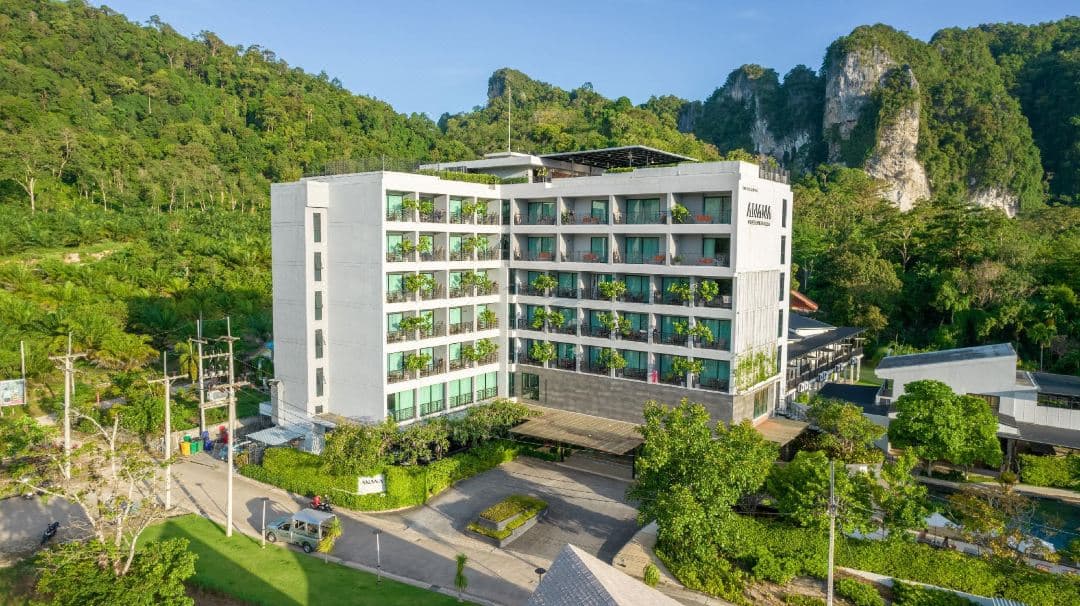 Anana Ecological Resort's 35m volcanic mineral infinity pool reflecting the limestone cliffs of Krabi at sunset.