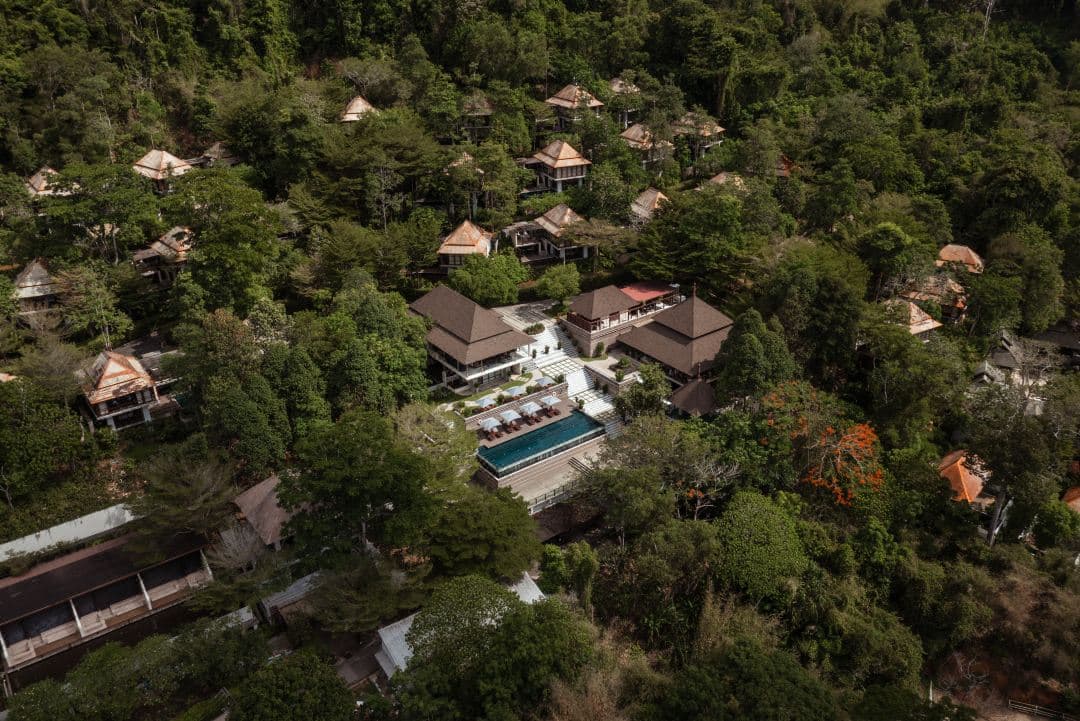 A Treetop Duplex Pool Villa at Villa Zolitude with a private infinity pool cantilevered over a dense jungle canopy at dusk.