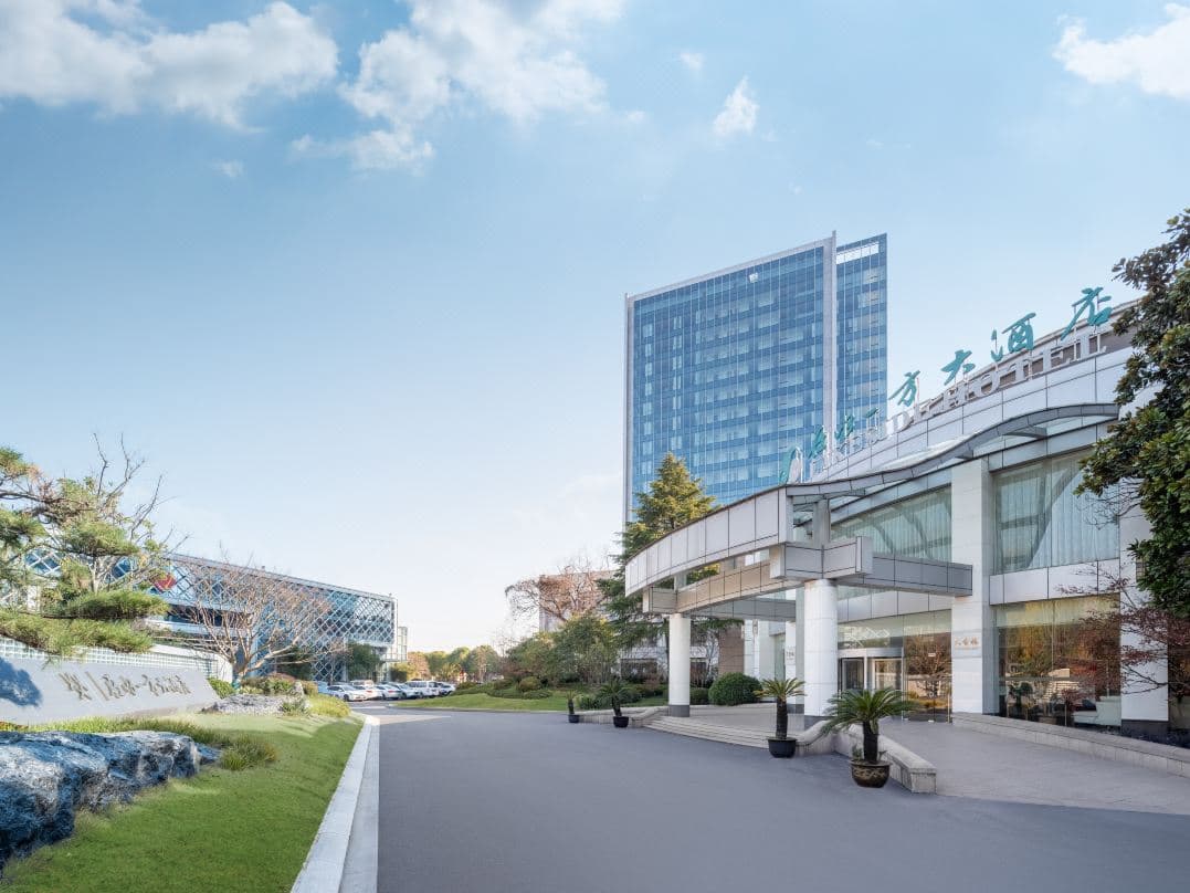 A symmetrical view of the Lakeside Hotel's massive 50-meter indoor swimming pool with floor-to-ceiling windows and natural light.