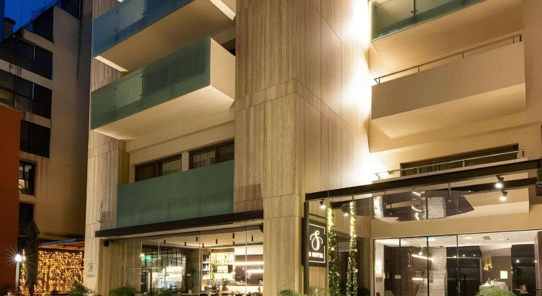 Glass floor in the lobby of S Hotel Boutique Thessaloniki revealing illuminated ancient ruins.
