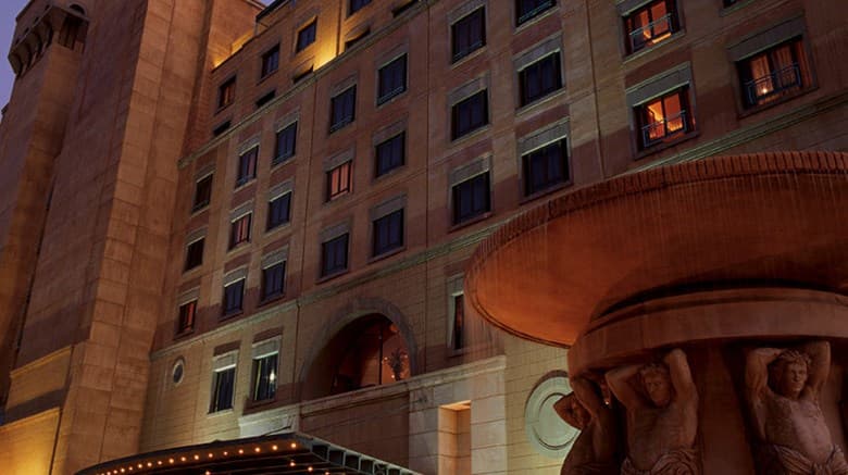 Low angle shot of The Michelangelo Hotel's Renaissance atrium featuring a glass dome roof and marble archways.