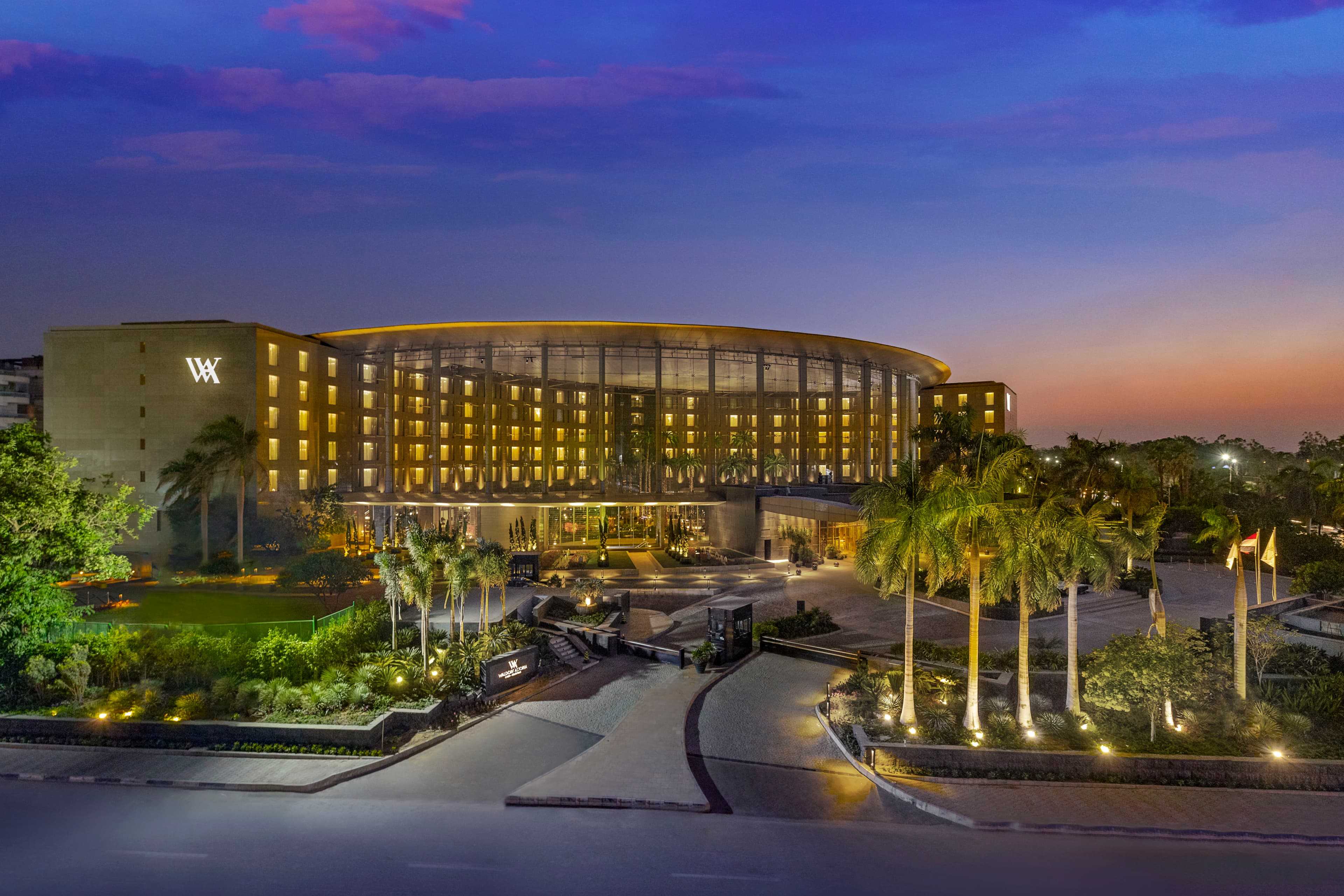 The Waldorf Astoria Cairo Heliopolis glass-domed atrium featuring the signature clock and Art Deco garden seating.