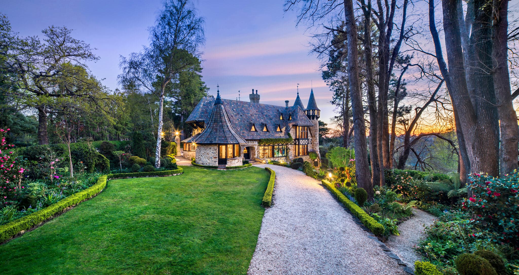 The crenellated stone tower of Thorngrove Manor rising above the trees in the Adelaide Hills.