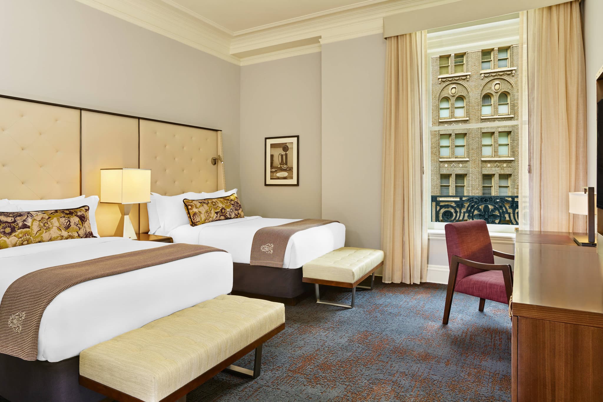 The sunlit Garden Court at The Palace Hotel San Francisco featuring a stained-glass dome and crystal chandeliers.