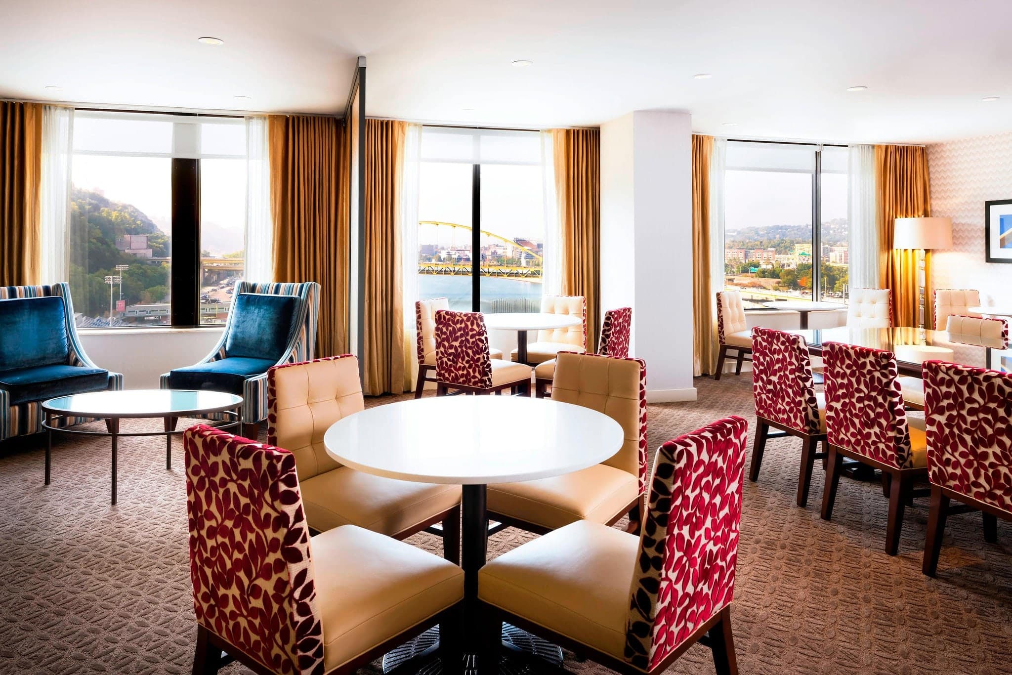 Panoramic view of the Pittsburgh skyline and Monongahela River seen from a high-floor window at Sheraton Station Square, framing the Smithfield Street Bridge.