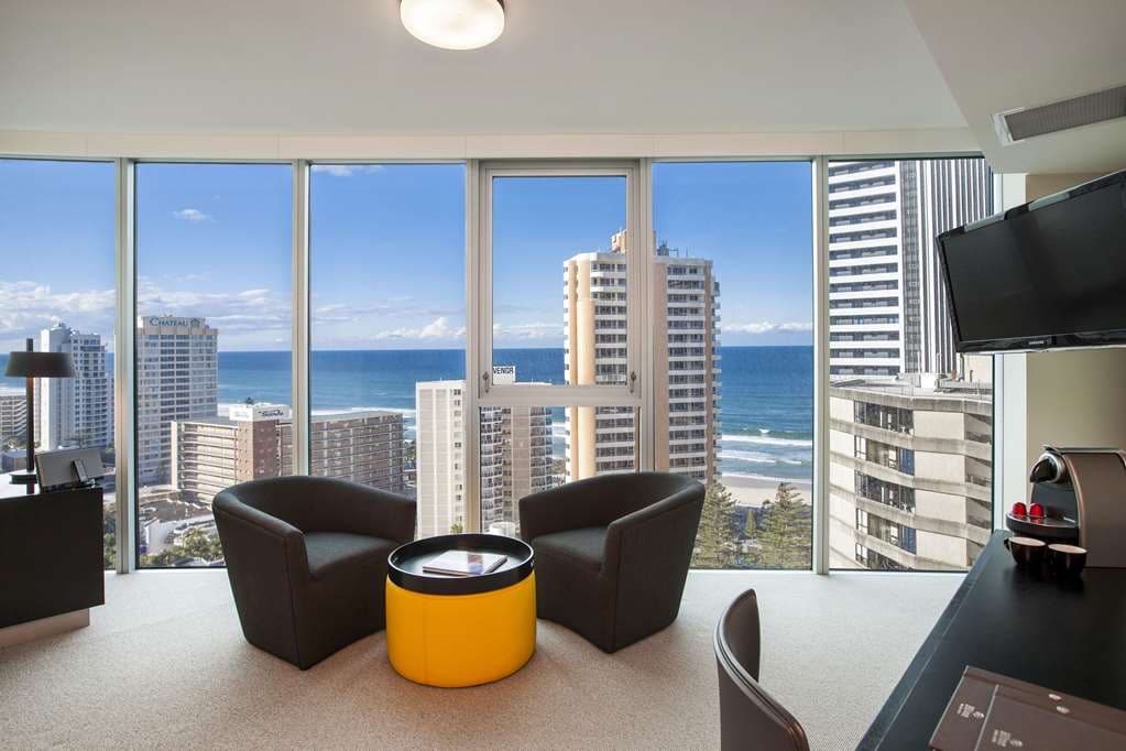 A sleek 40-meter outdoor lap pool at Hilton Surfers Paradise, framed by modern high-rise architecture and blue skies.
