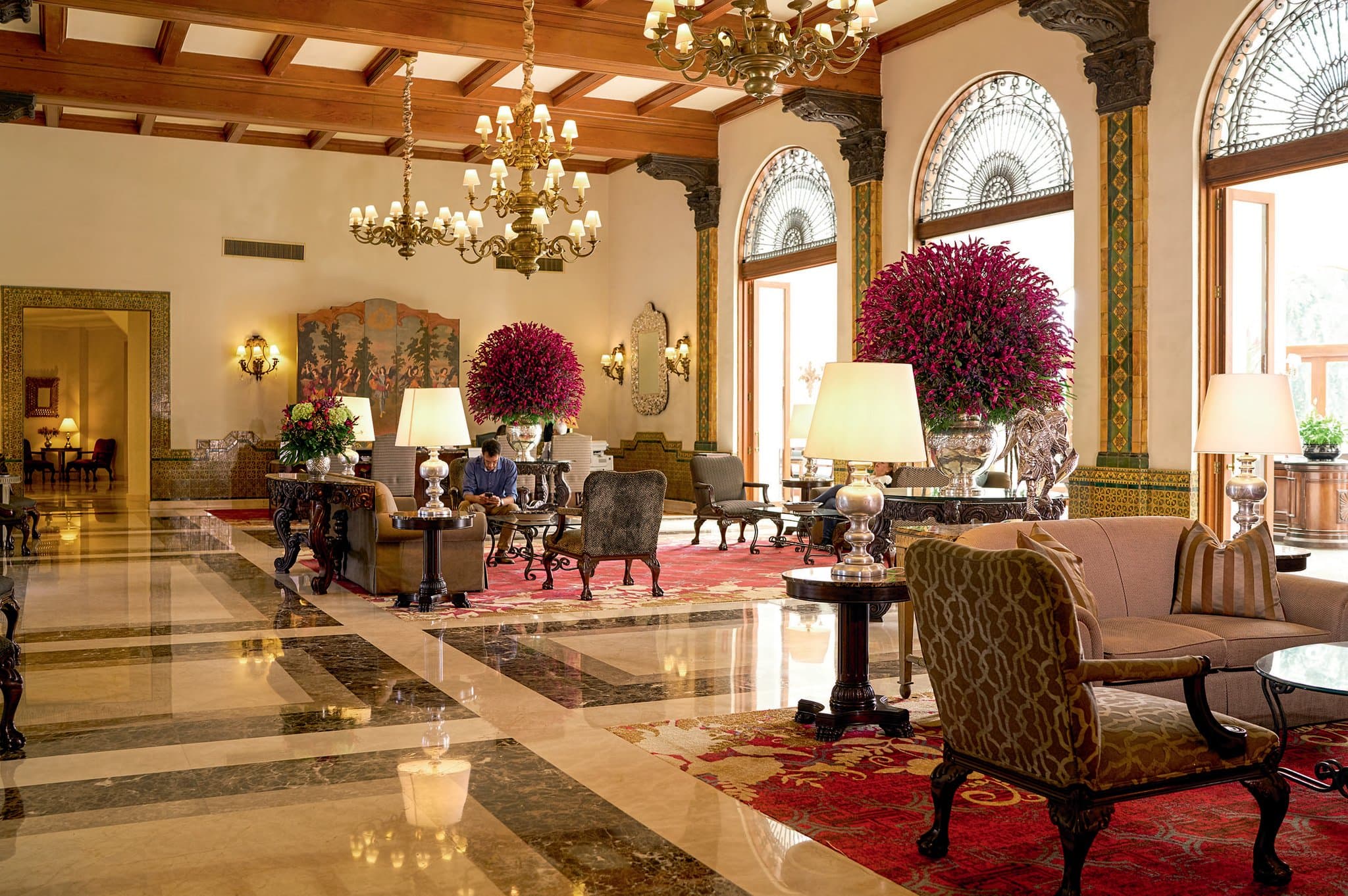 The grand stained glass ceiling of Los Vitrales lobby bar at Country Club Lima Hotel, illuminating viceregal artwork.