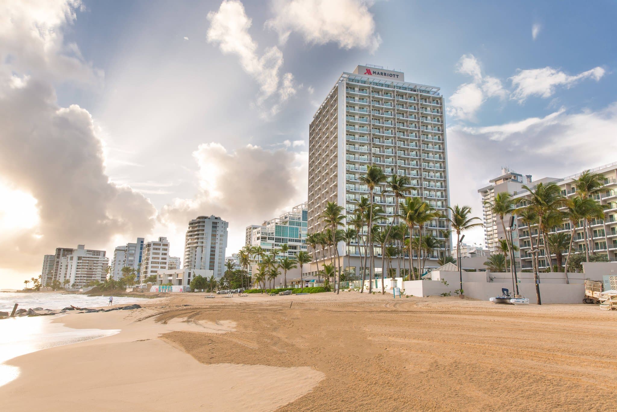 Aerial view of the San Juan Marriott Resort & Stellaris Casino pool deck featuring the double-helix water slide and direct access to Condado Beach.