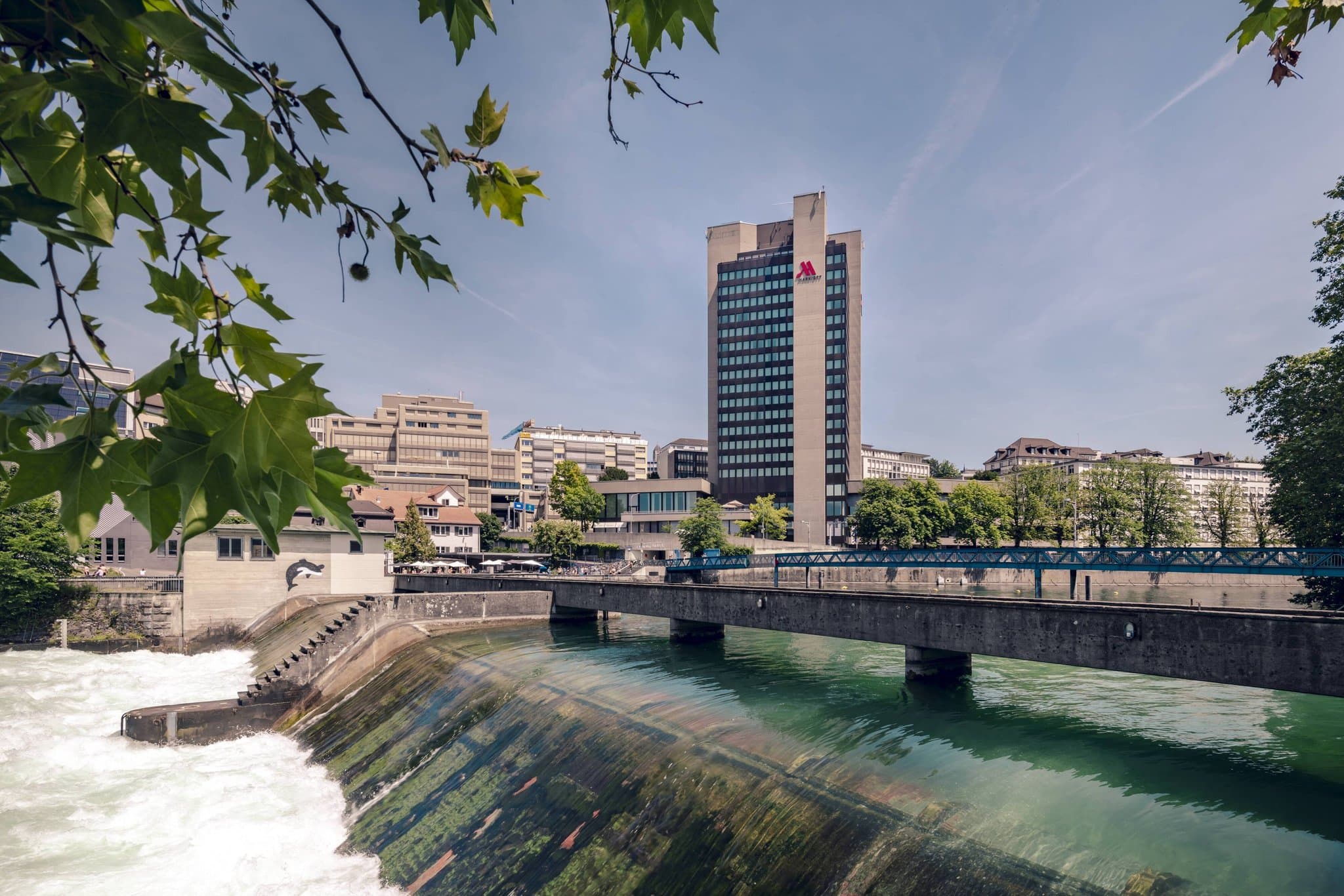 View from a high-floor suite at Zurich Marriott Hotel overlooking the River Limmat and city skyline through floor-to-ceiling windows.