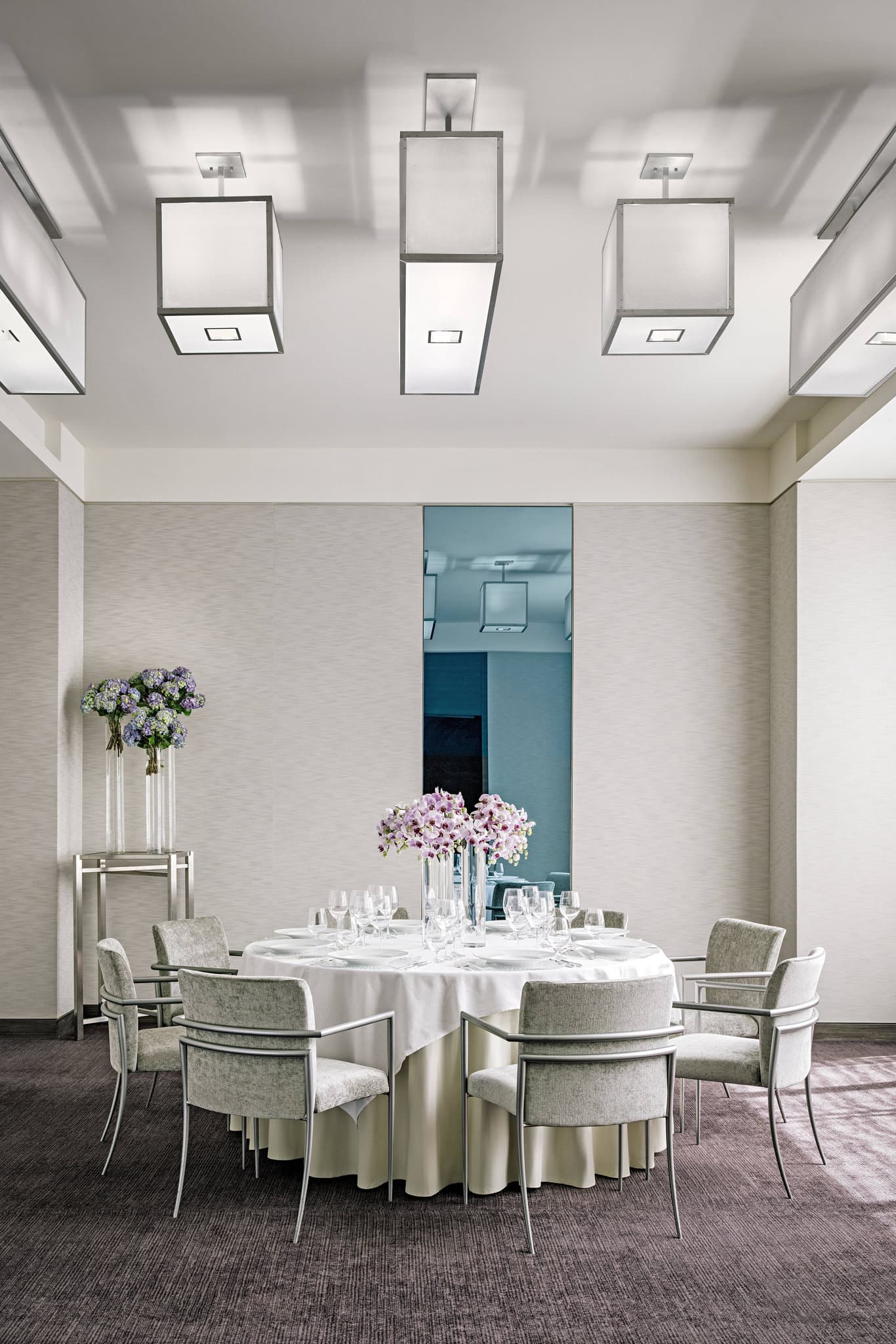 The moody, low-lit St. Regis Bar featuring illuminated brass shelving and velvet seating.