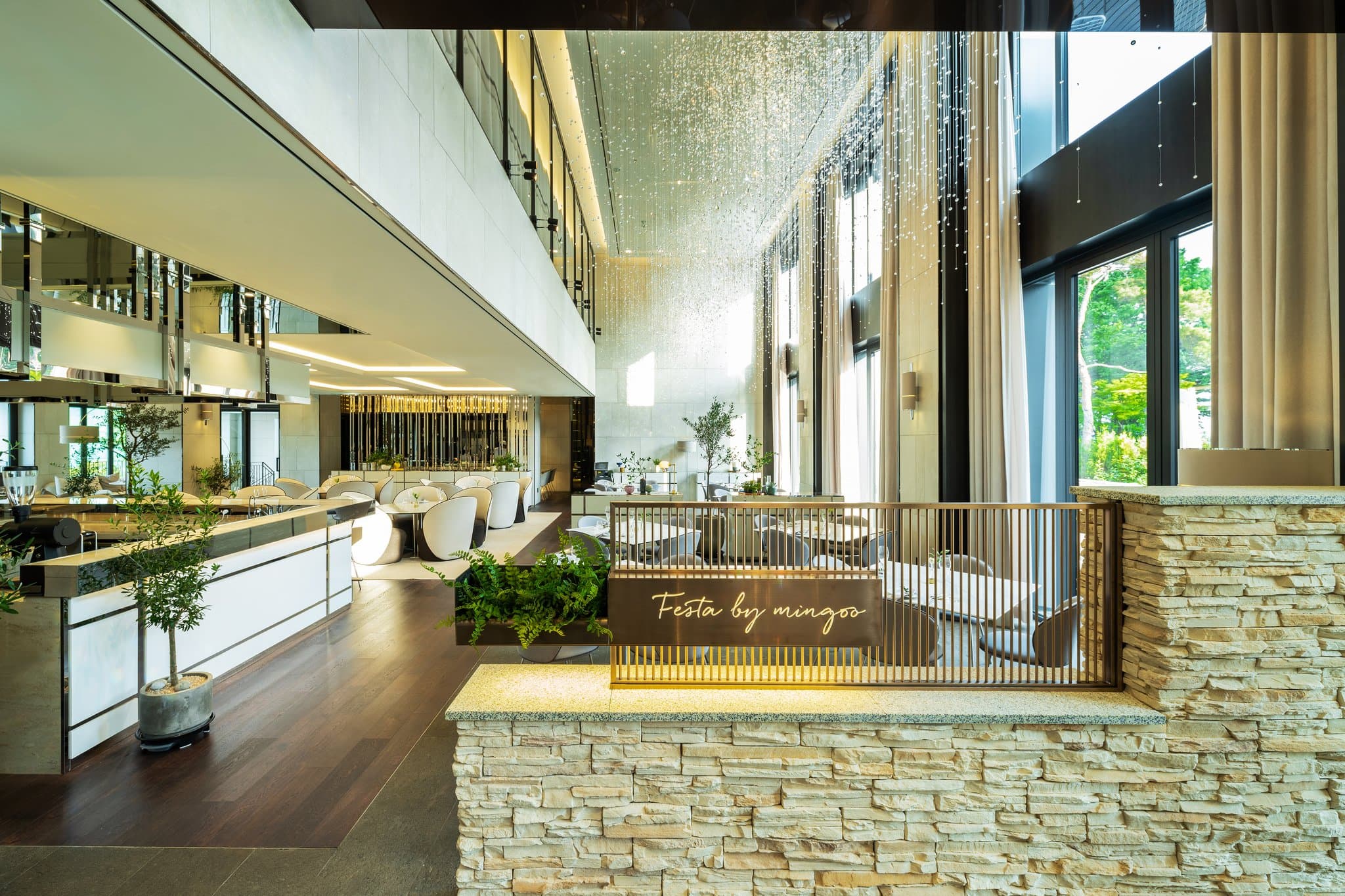 A guest relaxing in a private in-room stone plunge pool at Banyan Tree Seoul, with the illuminated N Seoul Tower visible through the floor-to-ceiling window at twilight.