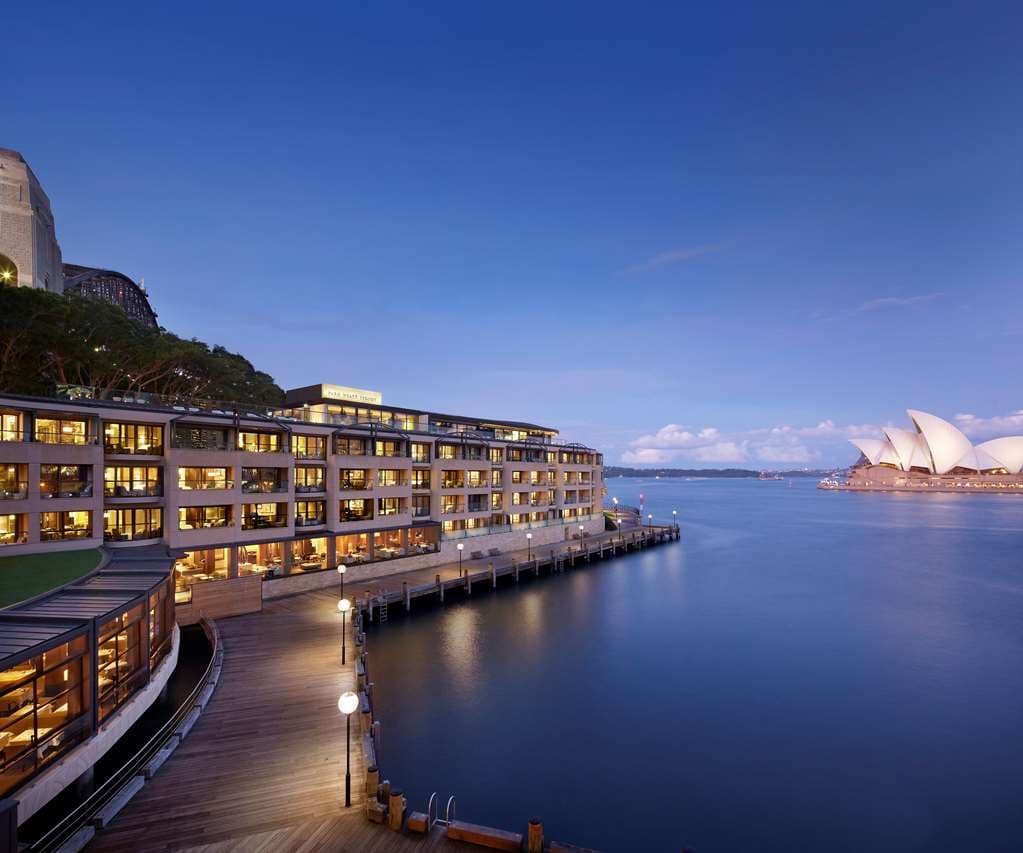 Guest relaxing on a private balcony at Park Hyatt Sydney with a direct, close-up view of the Sydney Opera House and harbour waters.