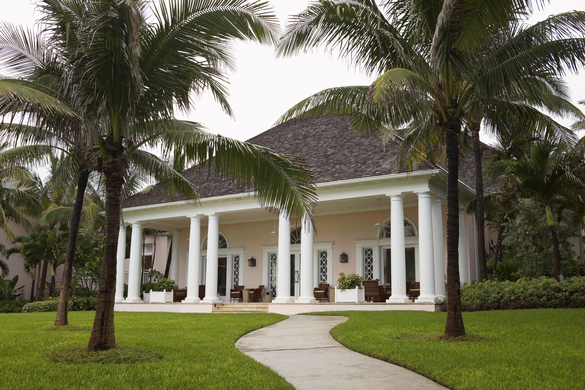 The tiered Versailles Gardens at The Ocean Club Bahamas leading up to the 12th-century French Cloisters at sunset.