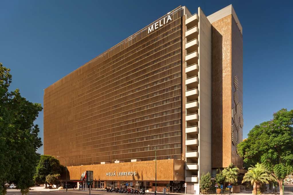 Meliá Lebreros outdoor lagoon pool surrounded by lush gardens and sun loungers in Seville.