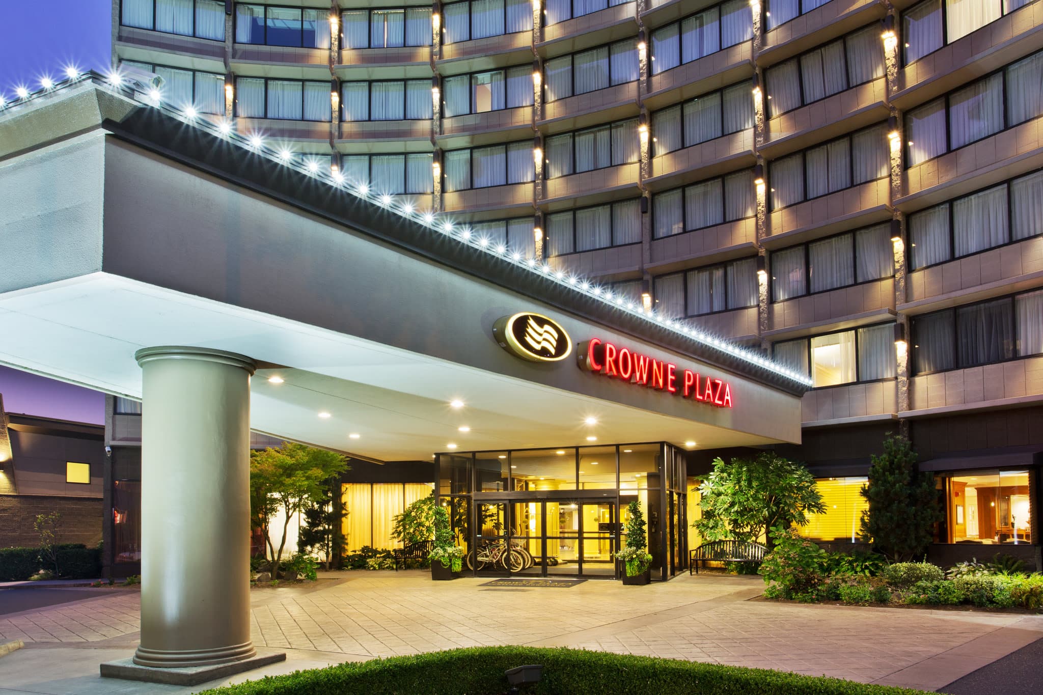 Indoor saltwater pool at Crowne Plaza Portland with retractable glass walls opening to a patio.