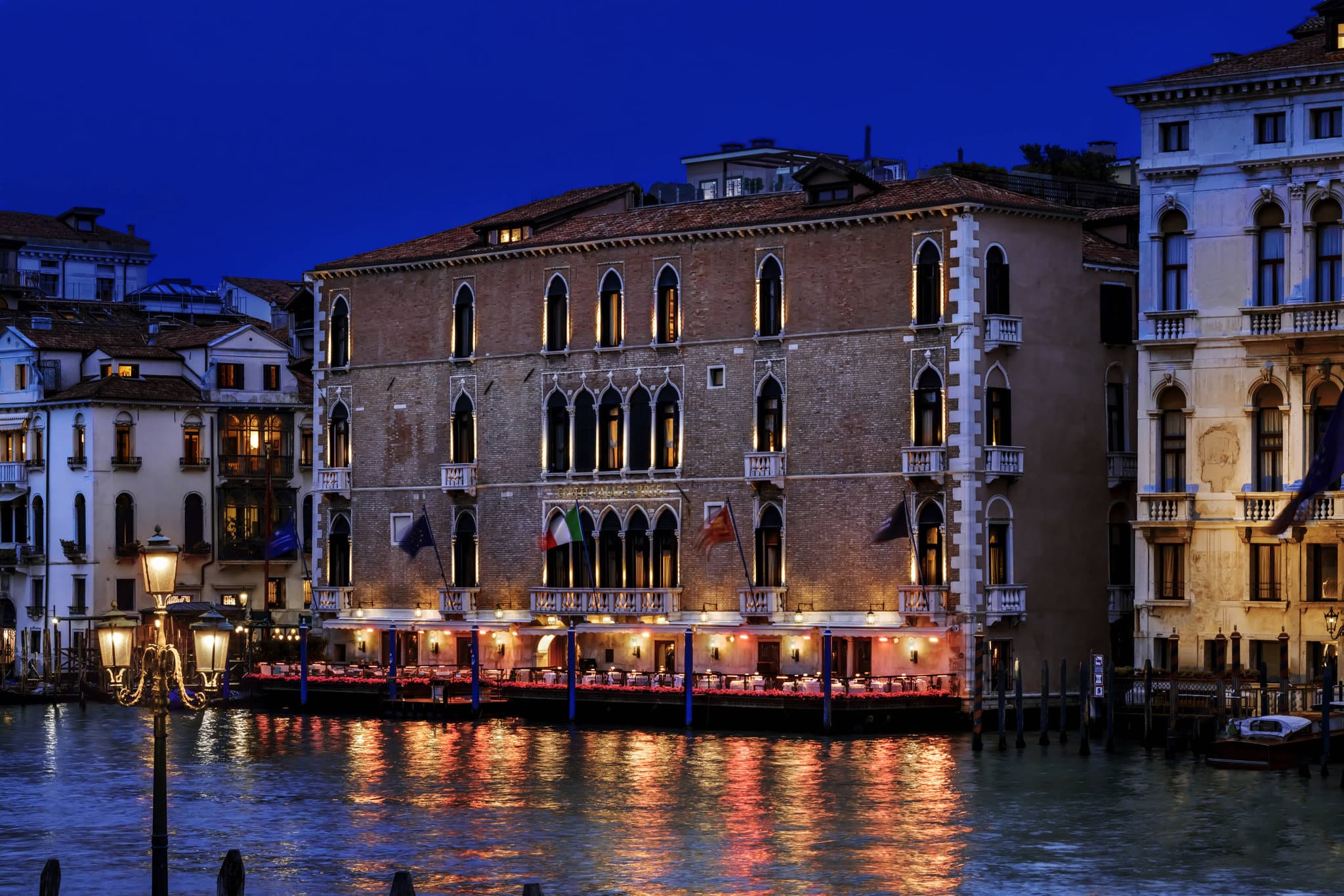 Diners enjoying lunch on the Gritti Terrace with a view of Santa Maria della Salute basilica across the Grand Canal.