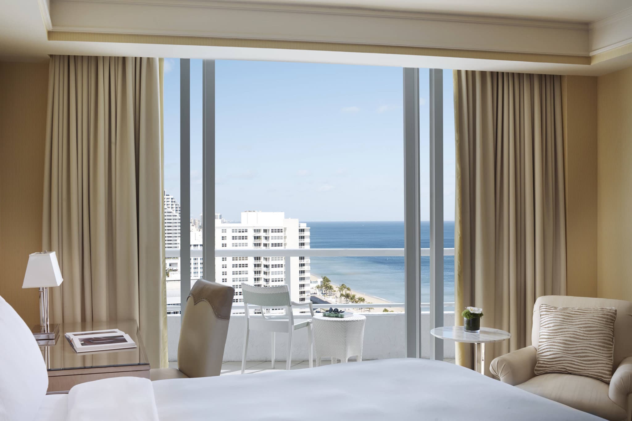 The Ritz-Carlton Fort Lauderdale elevated infinity pool deck overlooking the Atlantic Ocean at sunset.