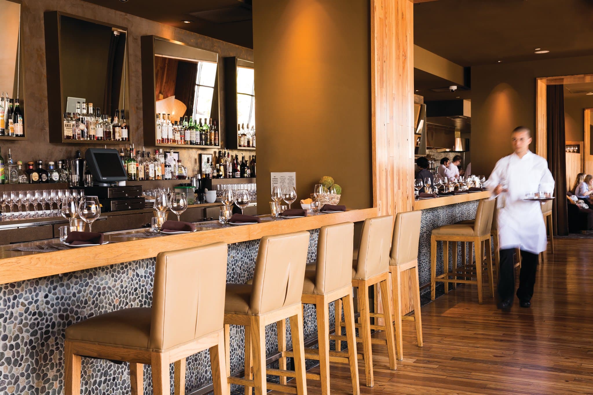 Lobby of 1 Hotel San Francisco featuring reclaimed wood beams, a living green wall, and comfortable lounge seating.