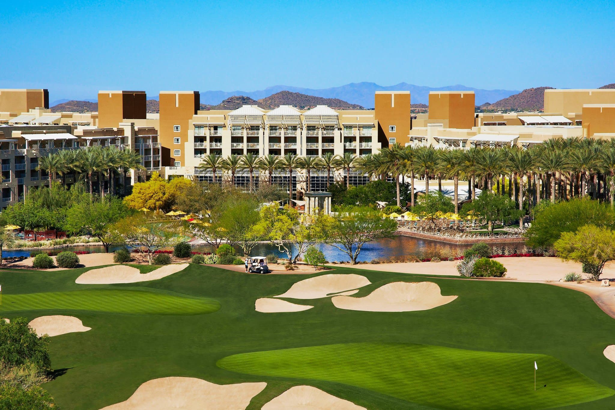 Aerial view of the AquaRidge Water Park at JW Marriott Phoenix Desert Ridge, featuring winding lazy rivers and multiple swimming pools against a desert mountain backdrop.