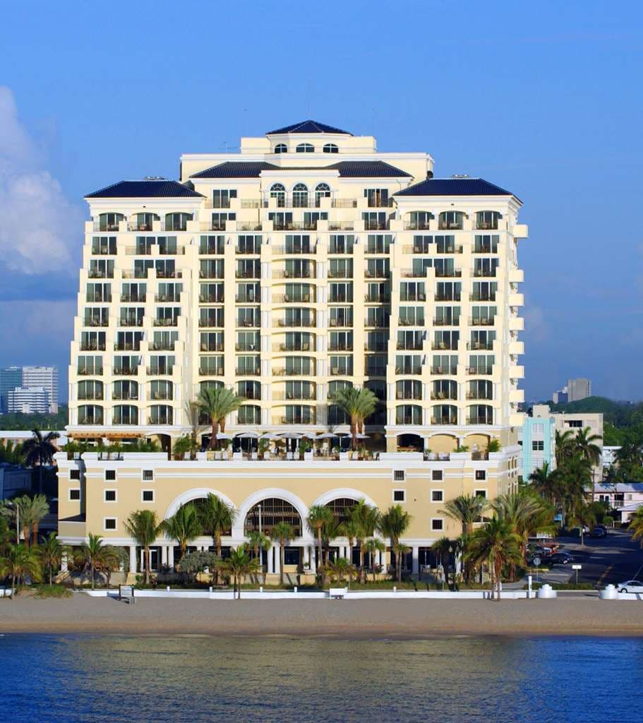 A guest relaxing on an oversized private balcony at The Atlantic Hotel & Spa, overlooking the Fort Lauderdale oceanfront.