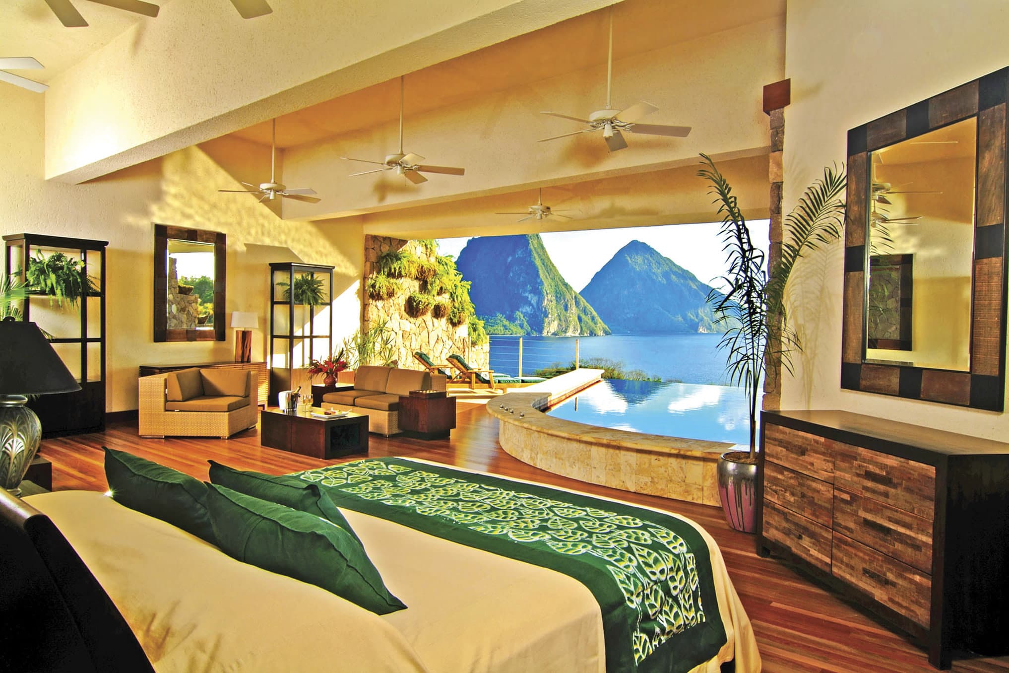 View from a Galaxy Sanctuary infinity pool at Jade Mountain Resort, looking out over the open fourth wall towards the Piton mountains and Caribbean Sea.