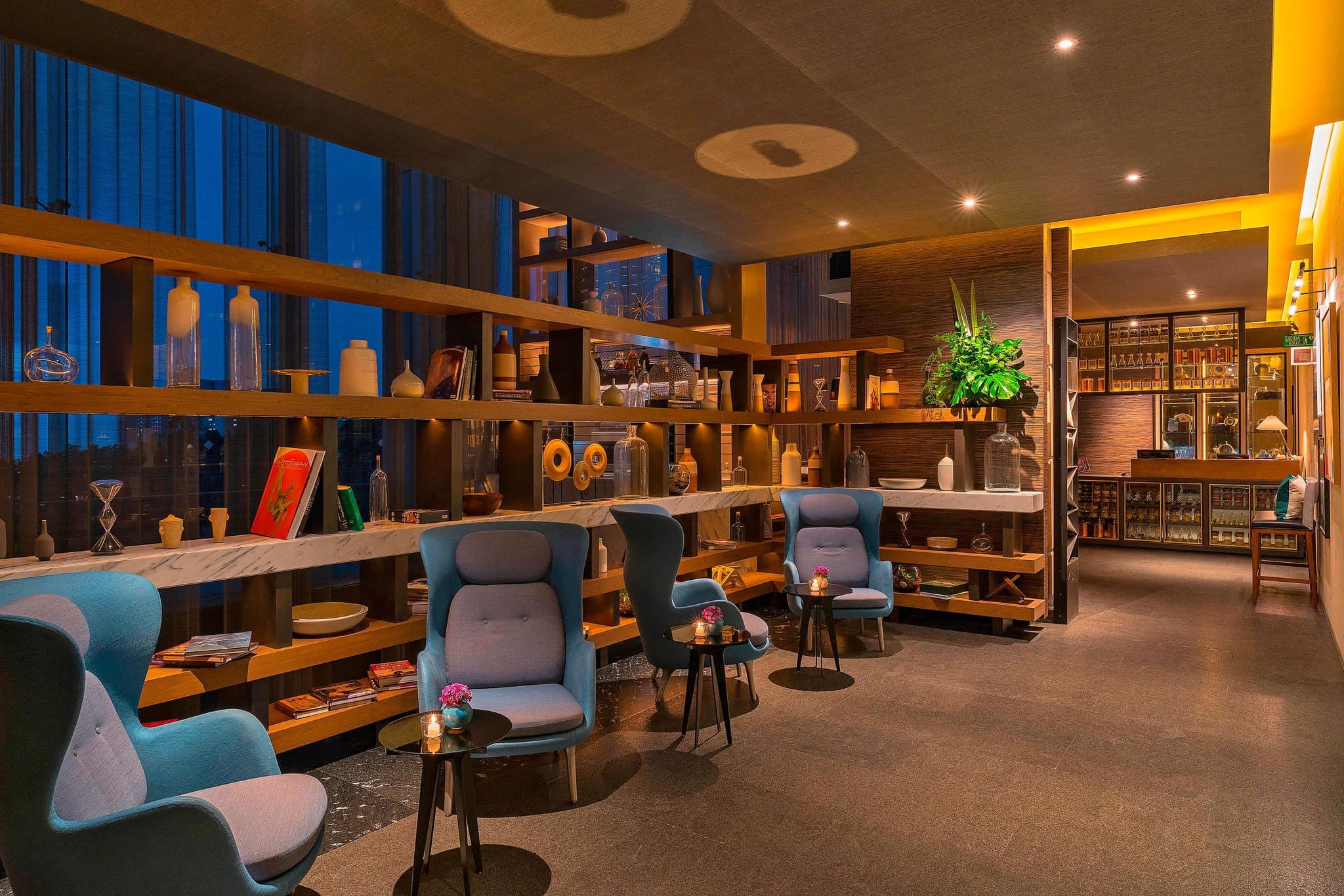 The Westin Santa Fe lobby atrium featuring floor-to-ceiling glass walls overlooking the green Santa Fe valley.