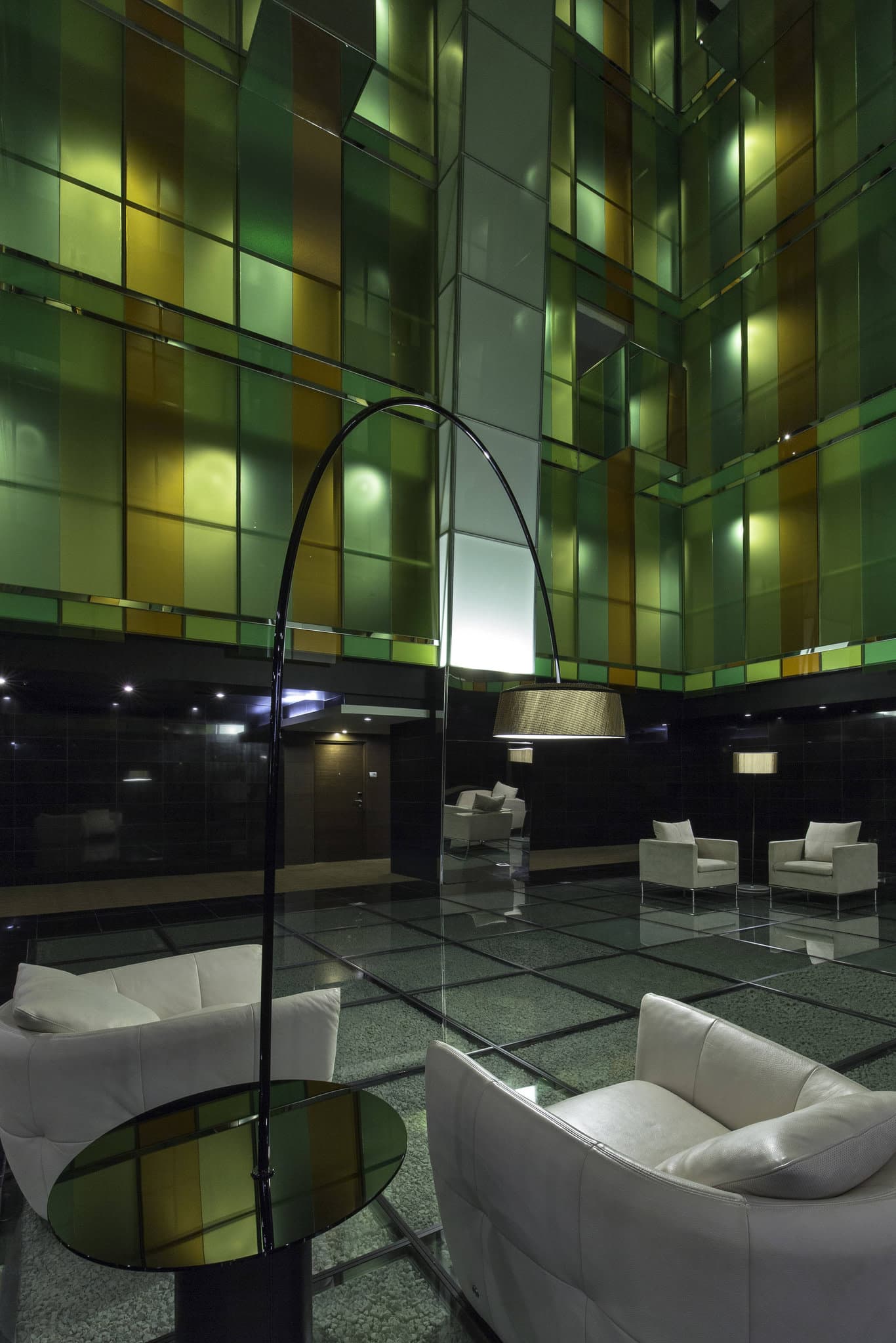 Looking up from the lobby of Le Méridien Panama at the dizzying 14-story atrium with glass elevators and an inverted gold pyramid chandelier.