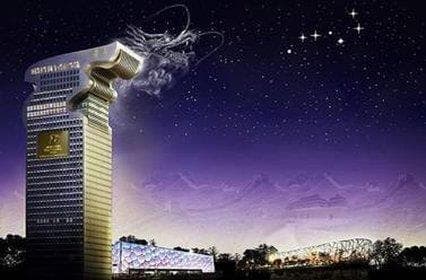 View from the Happiness Lounge at Pangu 7 Star Hotel showing the illuminated Bird's Nest stadium at night.