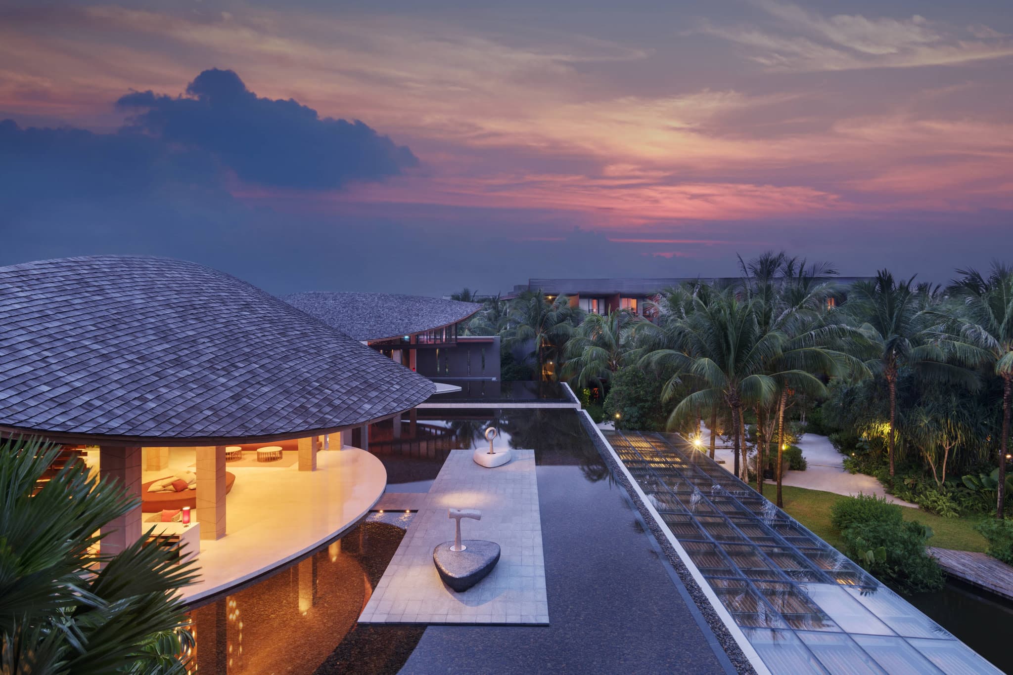 Aerial view of Renaissance Phuket Resort & Spa featuring the iconic turtle-shell rooflines of the lobby and the circular water garden of Quan Spa.