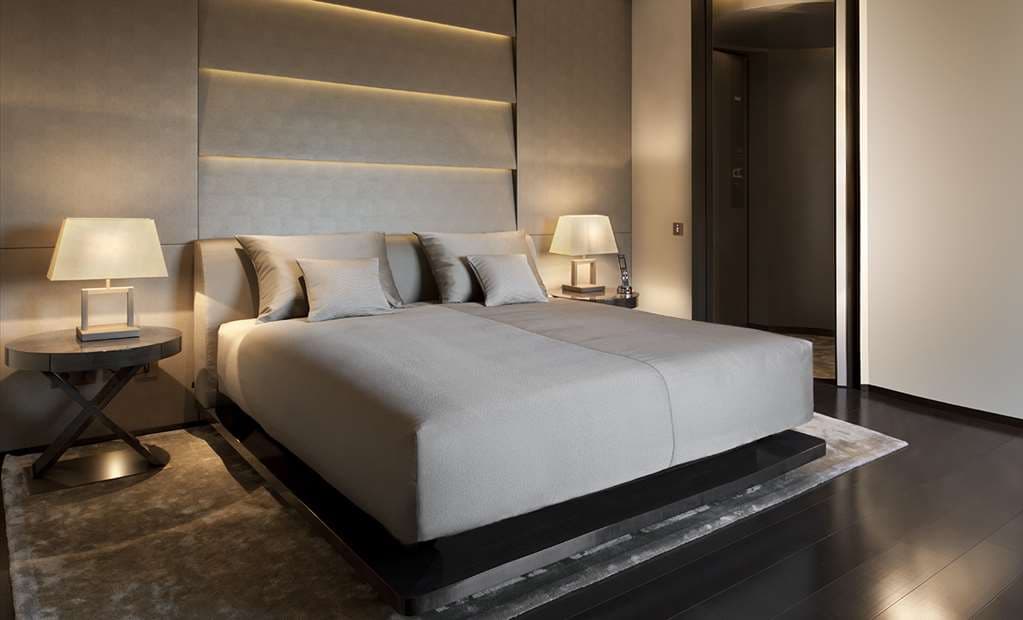 The backlit onyx walls and double-volume ceiling of the Armani/Bamboo Bar in Milan, with lounge seating and city views.