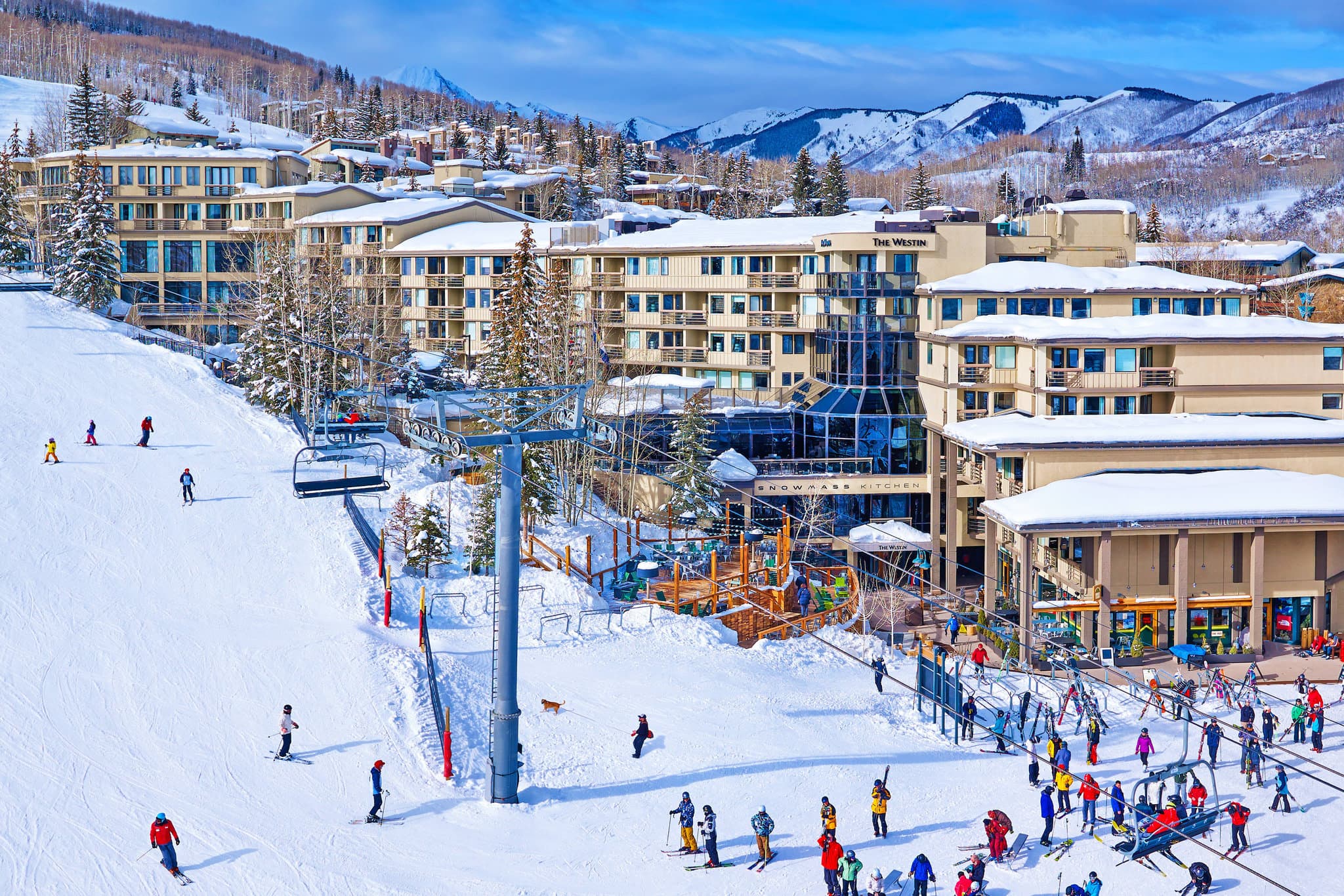 Viewline Resort Snowmass heated outdoor pool steaming in the winter with a view of the snowy ski slopes and Sky Cab gondola.