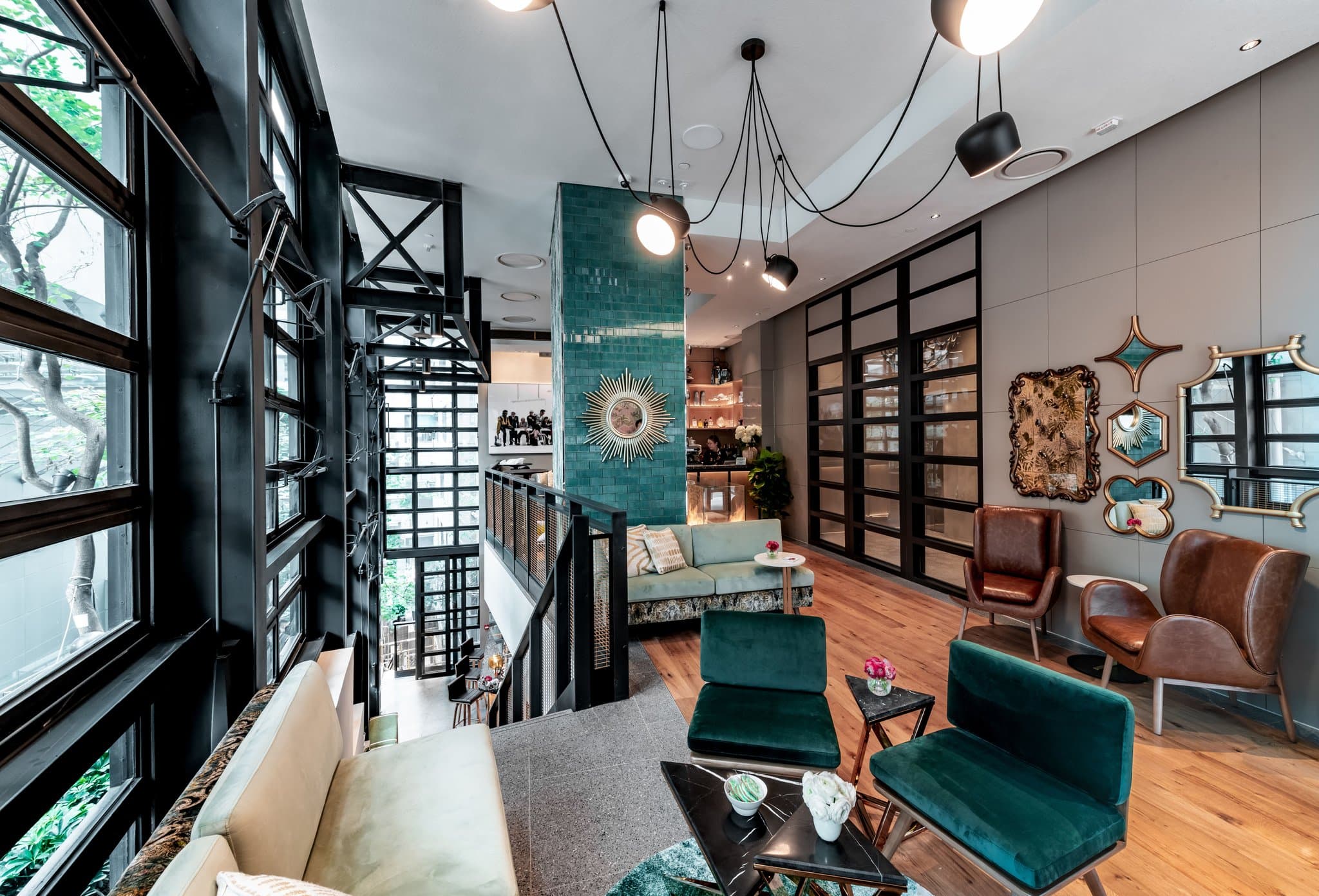 Lobby art at Ovolo Central featuring a painting of the Queen blowing bubblegum, set against industrial-chic interiors.