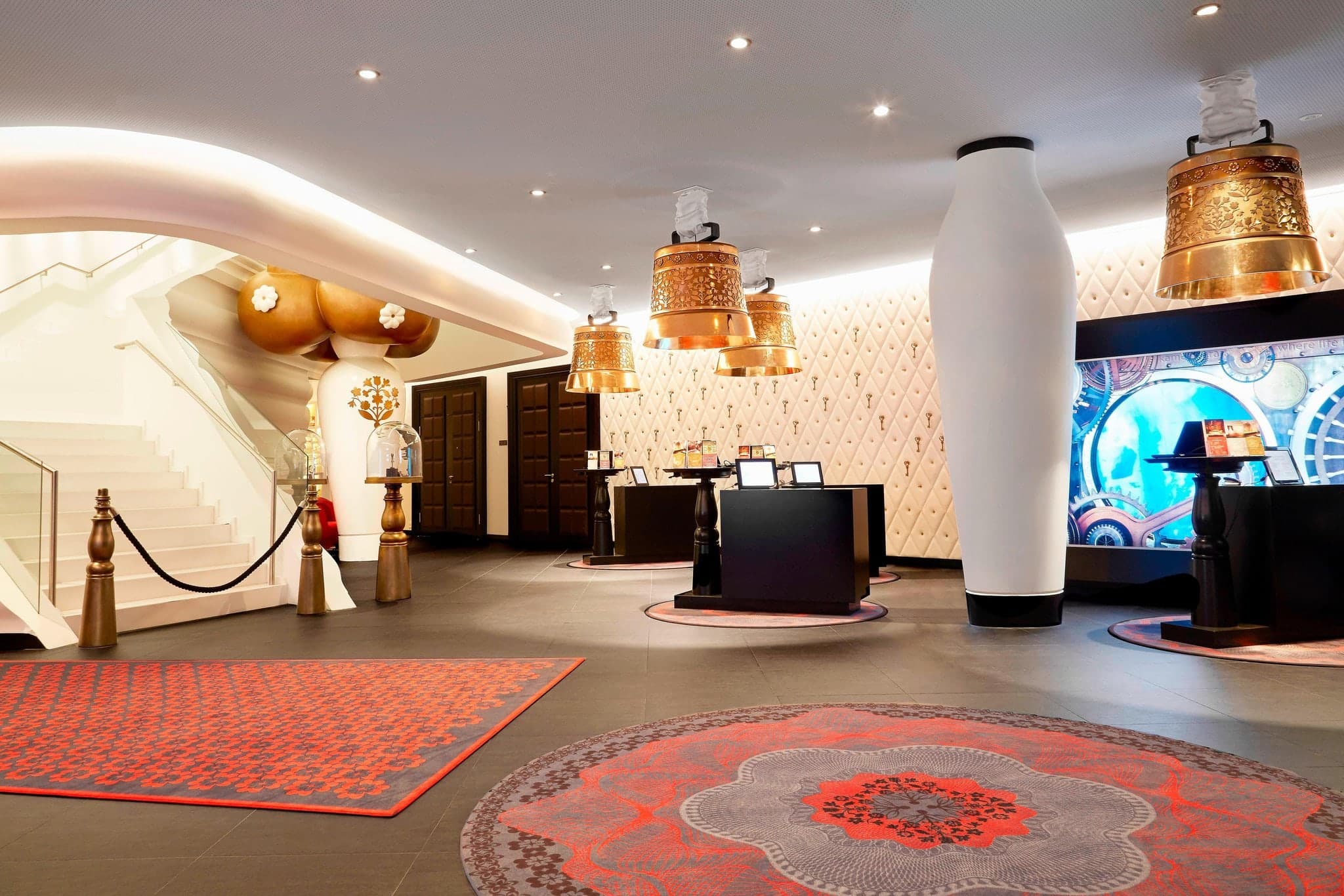 Interior of the Kameha Grand Zurich featuring Marcel Wanders' whimsical design with oversized bell lamps and neo-Baroque furniture.