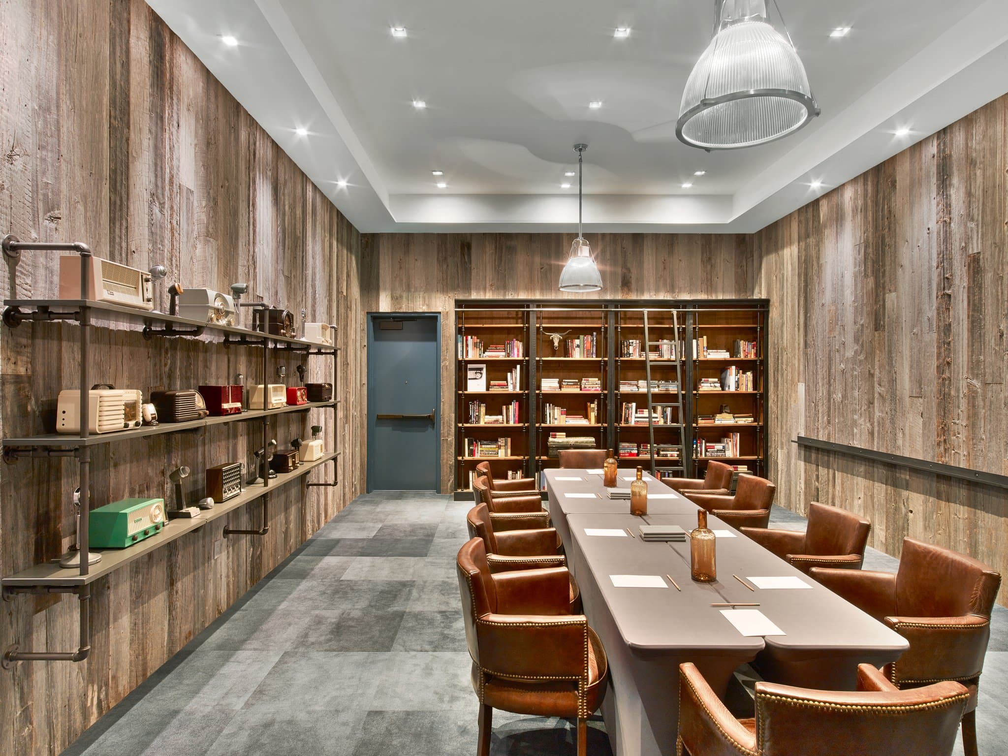 Hotel Van Zandt lobby featuring a ceiling installation of flying vinyl records and dark leather furniture.