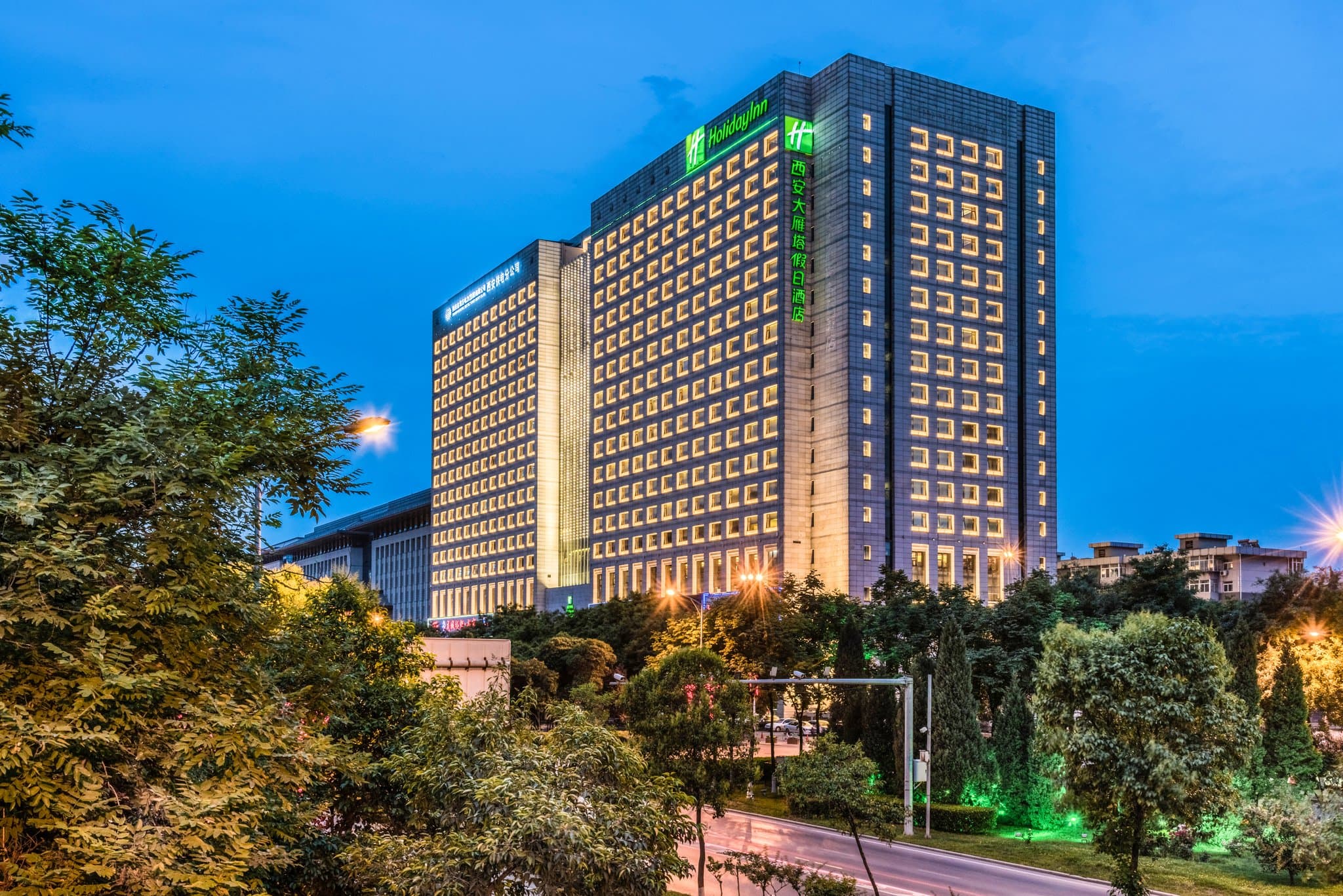 View from a high-floor room at Holiday Inn Xi'an featuring the illuminated Big Wild Goose Pagoda at night.