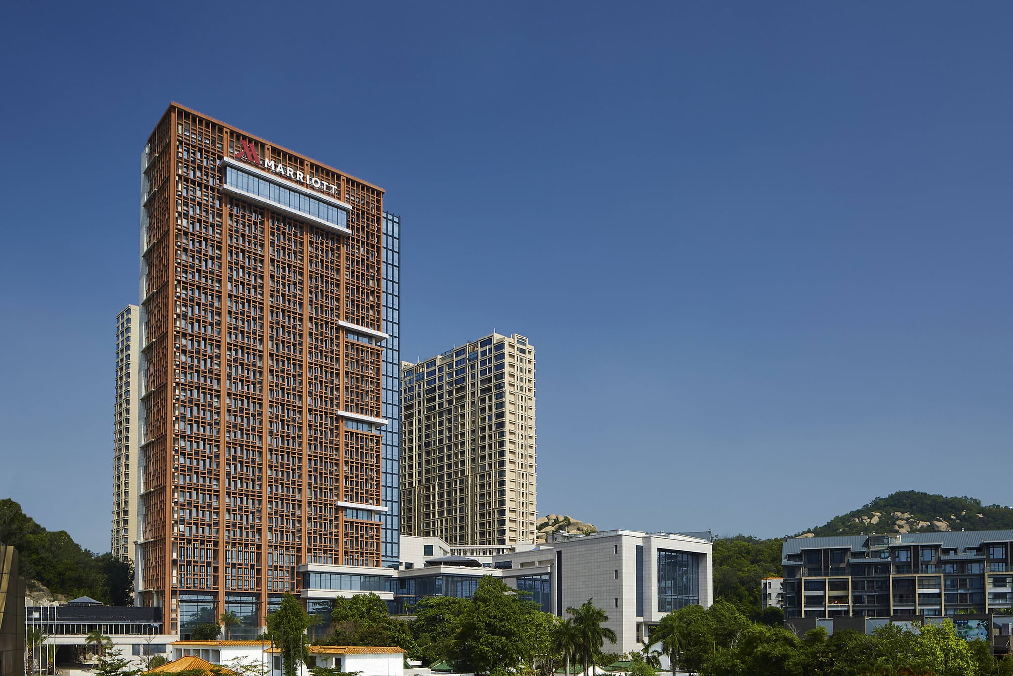 Modern exterior of Zhuhai Marriott Hotel featuring luxury rooms and an executive lounge near Gongbei Port.