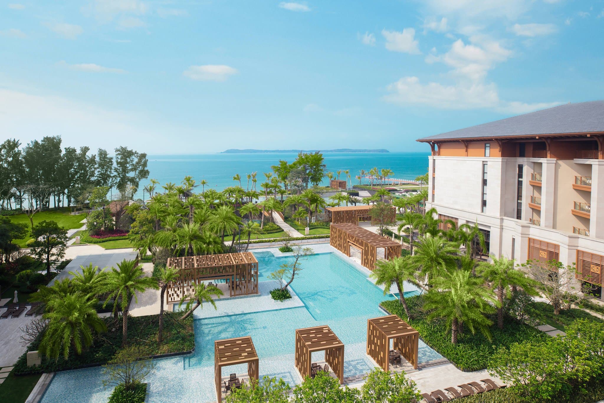View from a private balcony at Shenzhen Marriott Hotel Golden Bay overlooking the outdoor infinity pool and the ocean.