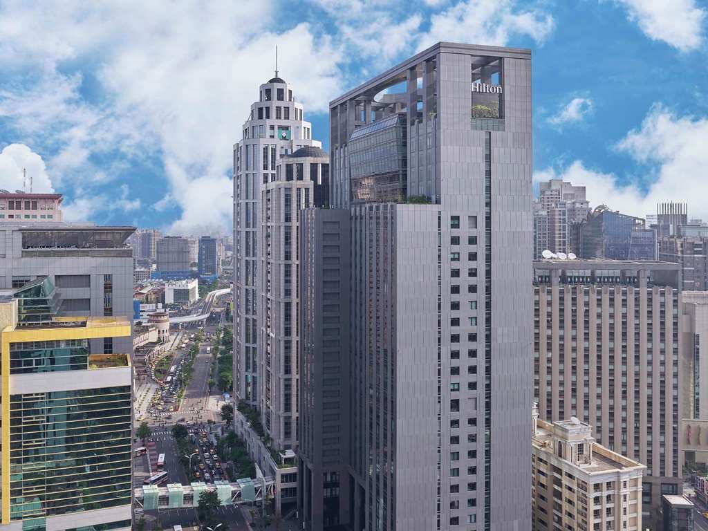 青雅中餐厅内厨师正在桌边片切招牌嫣红鹅，背景为现代中式装潢。