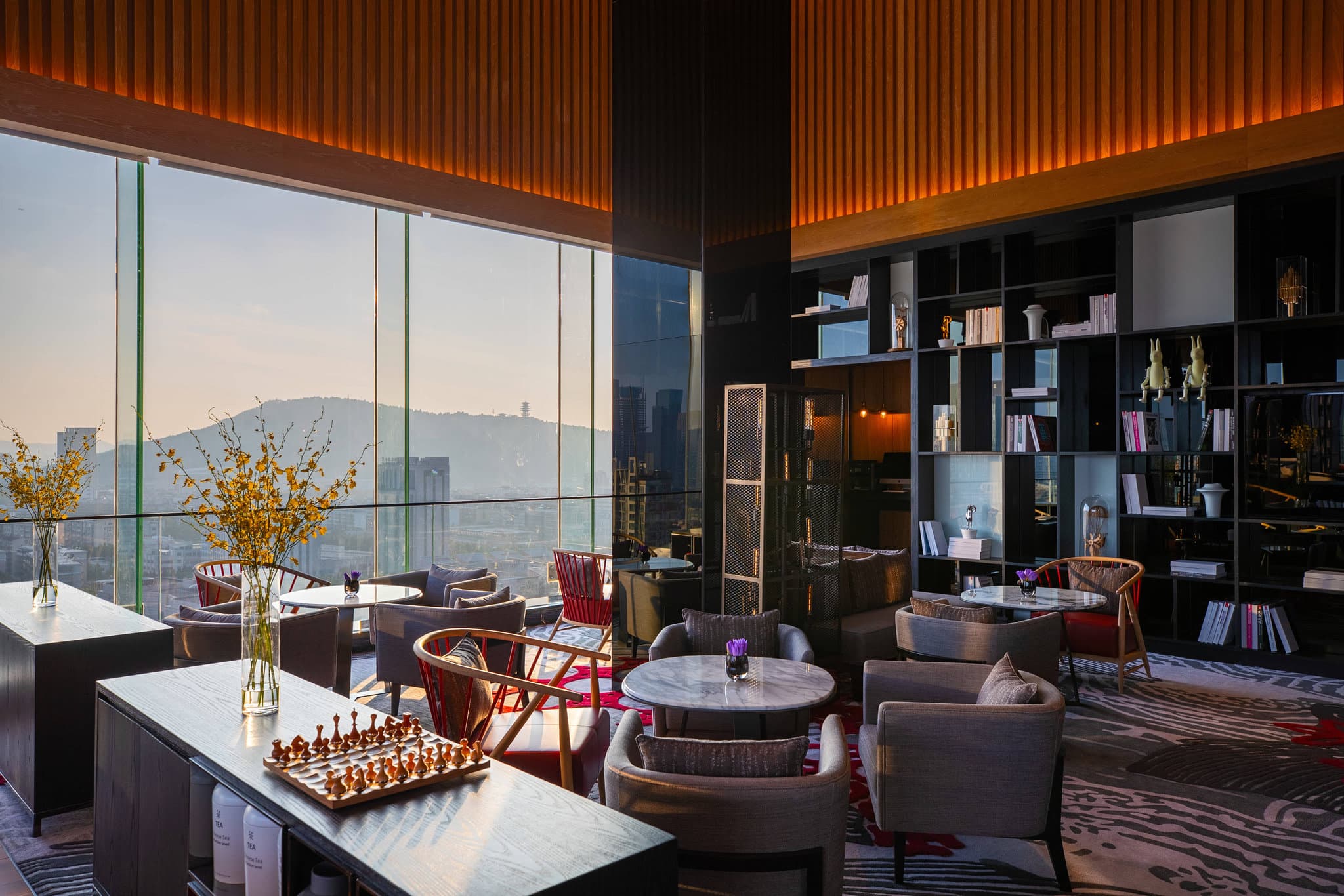 Spacious apartment-style room at Renaissance Hangzhou Northeast Hotel with modern amenities and large windows.