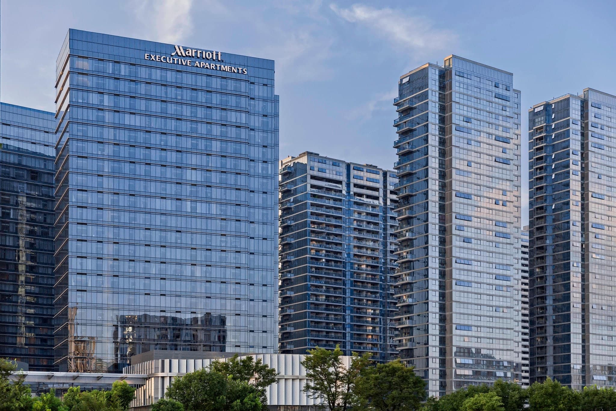 Spacious suite at Marriott Executive Apartments Hangzhou with modern decor and city views.