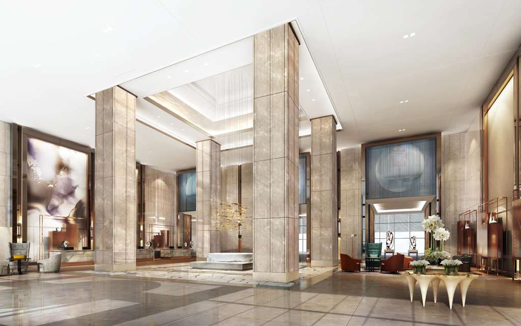 A sleek indoor swimming pool at Hilton Taizhou featuring floor-to-ceiling windows overlooking a landscaped Sky Garden.